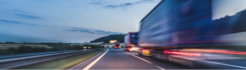 Multiple semis at dusk on a Florida highway